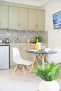 a kitchen with a table and a white chair at Sweet Home Naxos in Naxos Chora