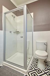 a bathroom with a shower and a toilet at Baleens Hotel in Hermanus