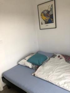 a bed with two pillows on it in a room at Appartements in Basel - Leymen in Leymen