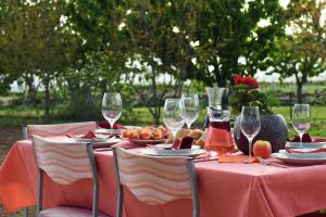 a table with wine glasses and food on it at EasyLiving House near Zadar in Posedarje
