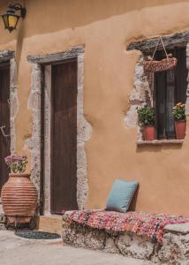 a couch sitting outside of a building with a window at La Casa Di Nonna in Koríthion