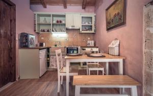 a kitchen with a table with a computer on it at La Casa Di Nonna in Koríthion