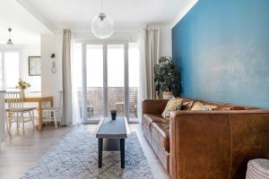 a living room with a couch and a table at Serenity Escape Marseille - T4 Vieux Port in Marseille