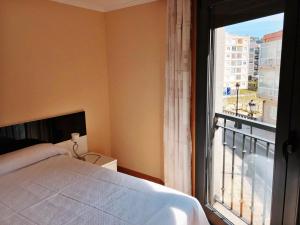 a bedroom with a bed and a large window at Apartamento Montolieu Sanxenxo in Sanxenxo +56 photos