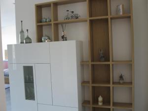 a kitchen with a white refrigerator and wooden shelves at Traumblick Vallendar in Vallendar