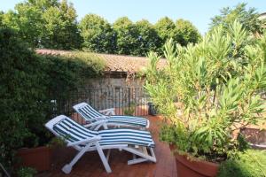 two blue and white chairs sitting on a patio at Studios Garden Terrace Oltrarno in Florence