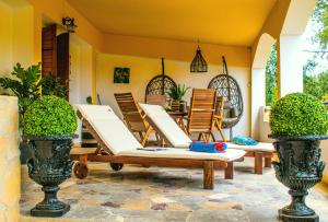 a patio with lounge chairs and a table at Villa-Maria in Triopetra
