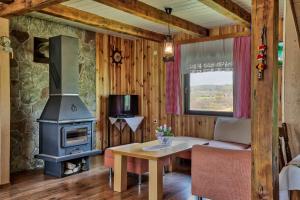 a living room with a wood stove and a table at Peace of Nature *** in Slunj