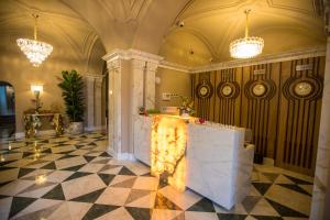 a lobby with a fireplace in the middle of a room at Promenade Hotel Baku in Baku