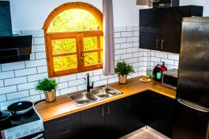 a kitchen with a sink and a window at Villa-Maria in Triopetra