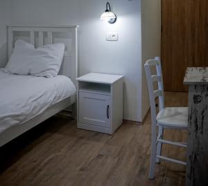 a bedroom with a bed and a table and a chair at Casa Rossa Motovun in Motovun