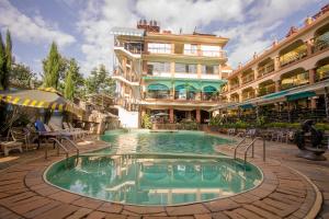 a hotel with a pool in front of a building at Aturukan Hotel in Kitale