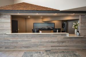 a living room with a stone wall and a television at Whitewater Inn in Big Sky