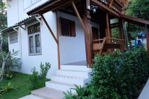 a house with stairs leading to the front of it at Paiyannoi Guesthome in Chiang Mai