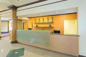 a lobby with a reception desk in a building at La Quinta by Wyndham Raleigh/Durham Southpoint in Durham