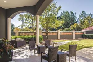 patio con sedie, tavoli e recinzione di La Quinta by Wyndham Atlanta Perimeter Medical ad Atlanta