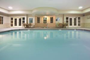 a large swimming pool with a table and chairs at La Quinta Inn & Suites by Wyndham Albuquerque Midtown in Albuquerque