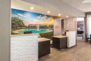 an office with a golf course mural on the wall at La Quinta by Wyndham Orlando UCF in Orlando