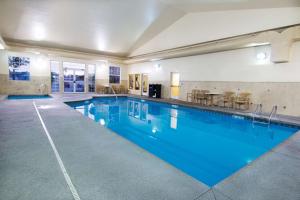 a large swimming pool with blue water in a building at Best Western Plus Kalispell/Glacier Park West Hotel & Suites in Kalispell
