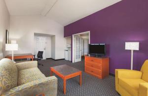 a living room with a couch and a tv at La Quinta Inn by Wyndham Midland in Midland