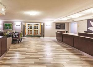 a lobby of a hotel with a bar and a restaurant at La Quinta Inn by Wyndham Odessa in Odessa