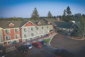 ein großes Gebäude mit Autos auf einem Parkplatz in der Unterkunft Best Western Plus Kalispell/Glacier Park West Hotel & Suites in Kalispell