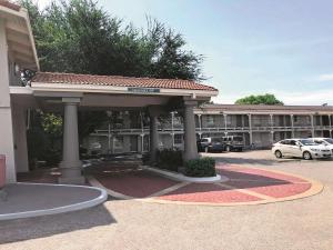 a large building with a parking lot in front of it at La Quinta Inn by Wyndham Dallas Uptown in Dallas