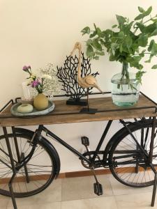 
a wooden table topped with a bicycle and a flower pot at Caloura Hotel Resort in Caloura
