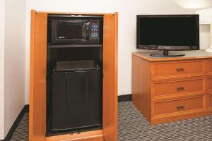 a room with a microwave and a refrigerator and a tv at La Quinta Inn by Wyndham Denver Westminster in Westminster