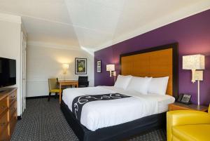 a hotel room with a large bed and a television at La Quinta Inn by Wyndham Denver Westminster in Westminster