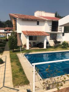 a house with a swimming pool in front of a house at San Jose Olympia in San Crist&oacute;bal de Las Casas