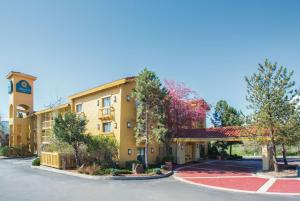 a hotel with a clock tower and a parking lot at La Quinta Inn by Wyndham Denver Westminster in Westminster