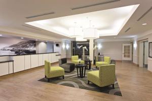 a lobby of a hotel with chairs and a table at La Quinta by Wyndham Santa Clarita - Valencia in Stevenson Ranch