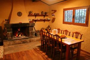 a dining room with a table and a fireplace at Casa Tajinastes del Teide in Las Cañadas del Teide