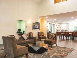 a lobby with a couch and chairs and a table at La Quinta Inn by Wyndham Vancouver Airport in Richmond