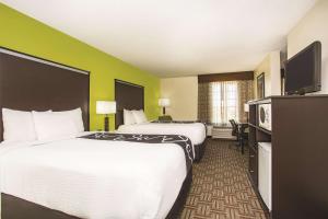 
a hotel room with two beds and a television at La Quinta by Wyndham Fruita in Fruita
