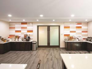 a large kitchen with wooden floors and a door at La Quinta Inn by Wyndham Vancouver Airport in Richmond