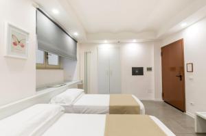 Postel nebo postele na pokoji v ubytování Hotel Tempio Di Pallade