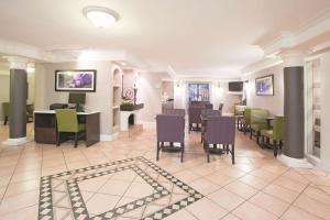 a dining room with a table and chairs and a dining room at La Quinta Inn by Wyndham Salt Lake City Midvale in Midvale