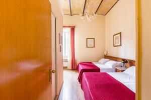 Postel nebo postele na pokoji v ubytování Hotel Tempio Di Pallade
