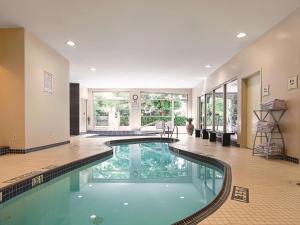 a swimming pool in the middle of a house at La Quinta Inn by Wyndham Vancouver Airport in Richmond