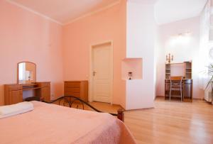 a bedroom with a bed and a table in a room at Home Hotel Apartments on Mykhailivska Square - Kiev in Kyiv