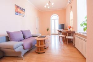 a living room with a couch and a table at Home Hotel Apartments on Mykhailivska Square - Kiev in Kyiv