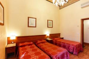 Postel nebo postele na pokoji v ubytování Hotel Tempio Di Pallade