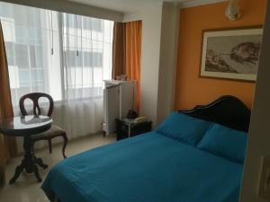 Postel nebo postele na pokoji v ubytování HOTEL COSTA DEL SOL FUSAGASUGa