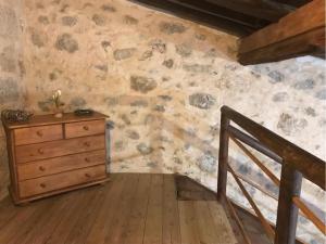 a room with a dresser and a stone wall at Casa Princess Arminda in Betancuría