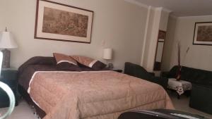 Postel nebo postele na pokoji v ubytování HOTEL COSTA DEL SOL FUSAGASUGa