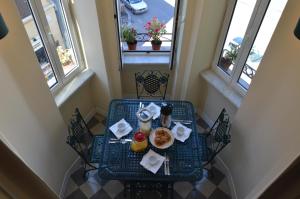 a table with breakfast food on it in a room with windows at Paola A Trastevere in Rome