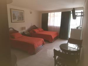 Postel nebo postele na pokoji v ubytování HOTEL COSTA DEL SOL FUSAGASUGa