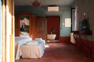 a bedroom with a bed with a tub and a sink at Corte Mantovanella in SantʼAntonio